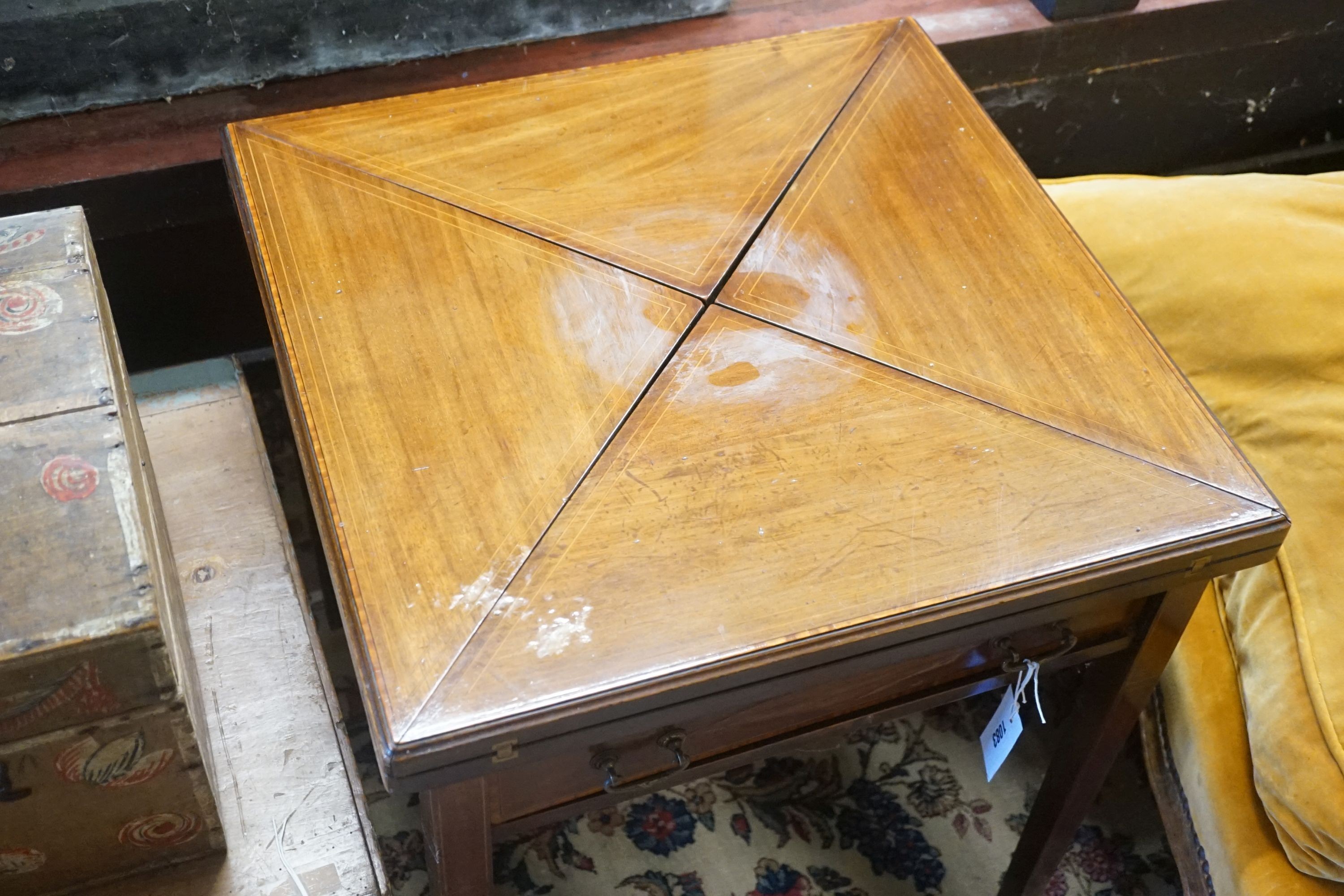 An Edwardian mahogany envelope card table, (cut down), width 56cm, depth 56cm, height 60cm